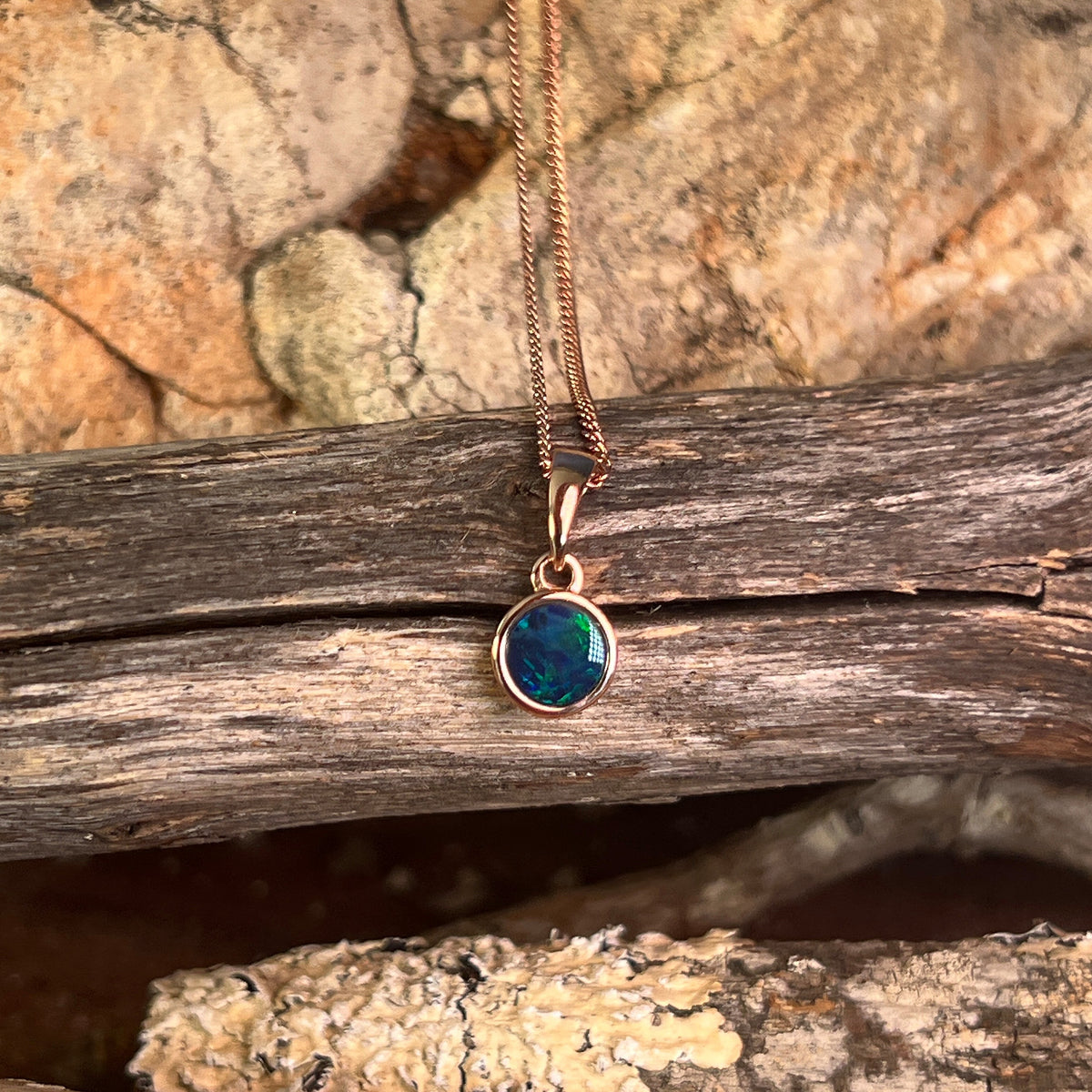 green, red and blue play-of-colour in a 6mm round Australian opal doublet pendant
