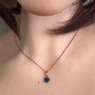 Australian opal doublet pendant worn, 6mm round stone in rose gold-plated silver