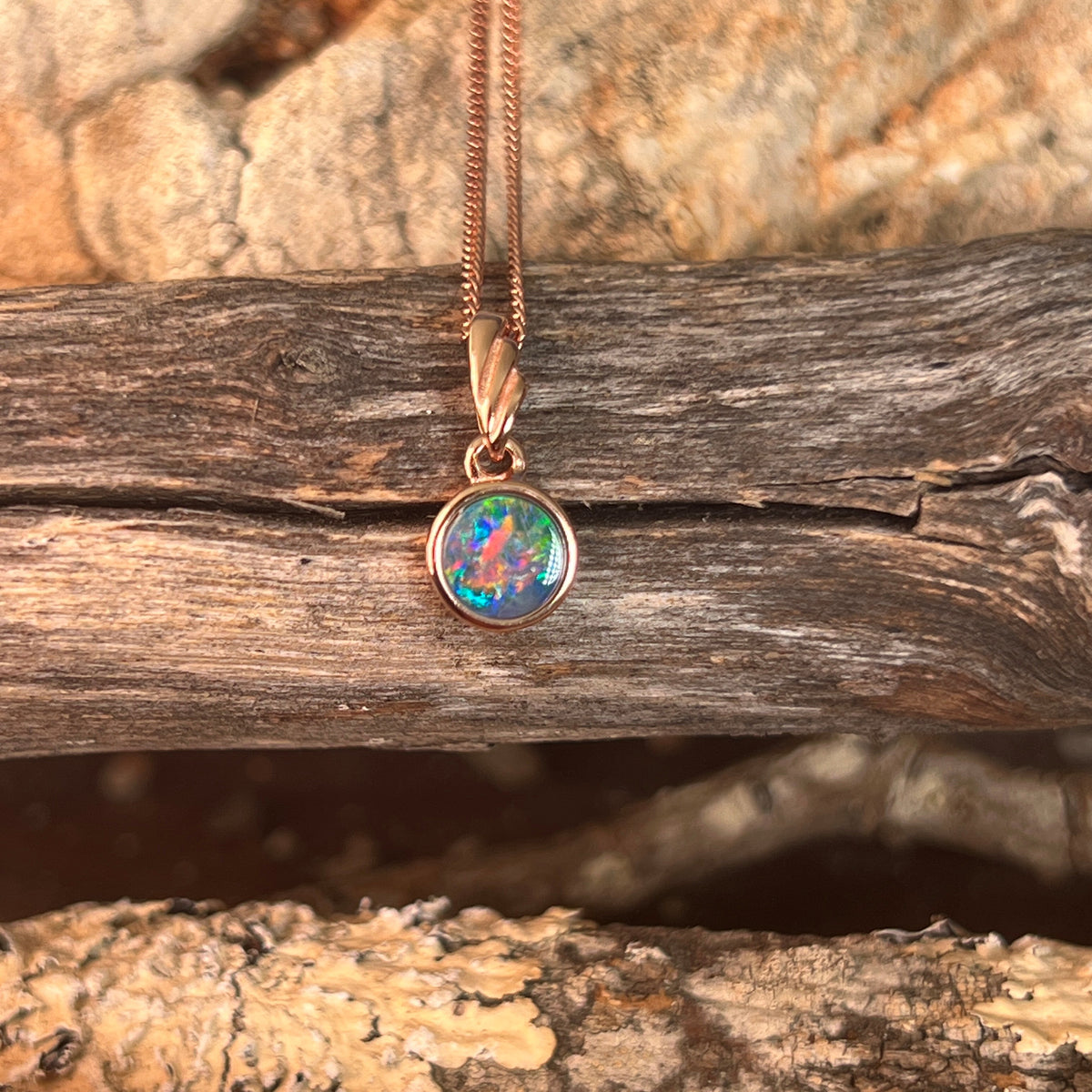 round Australian opal doublet pendant in rose gold-plated silver, green, red, blue and yellow play-of-colour