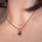 6mm round Australian opal doublet pendant worn at the neck, rose gold-plated silver