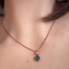 Worn Australian opal doublet pendant in rose gold-plated silver, green, red, blue and yellow, 6mm