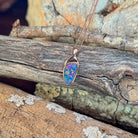 blue, yellow, green and red play-of-colour in a 11 x 5.5mm triangular Australian opal doublet pendant