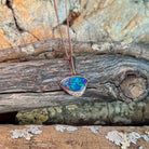 blue, yellow, green and red play-of-colour in a 13 x 7mm triangular Australian opal doublet pendant