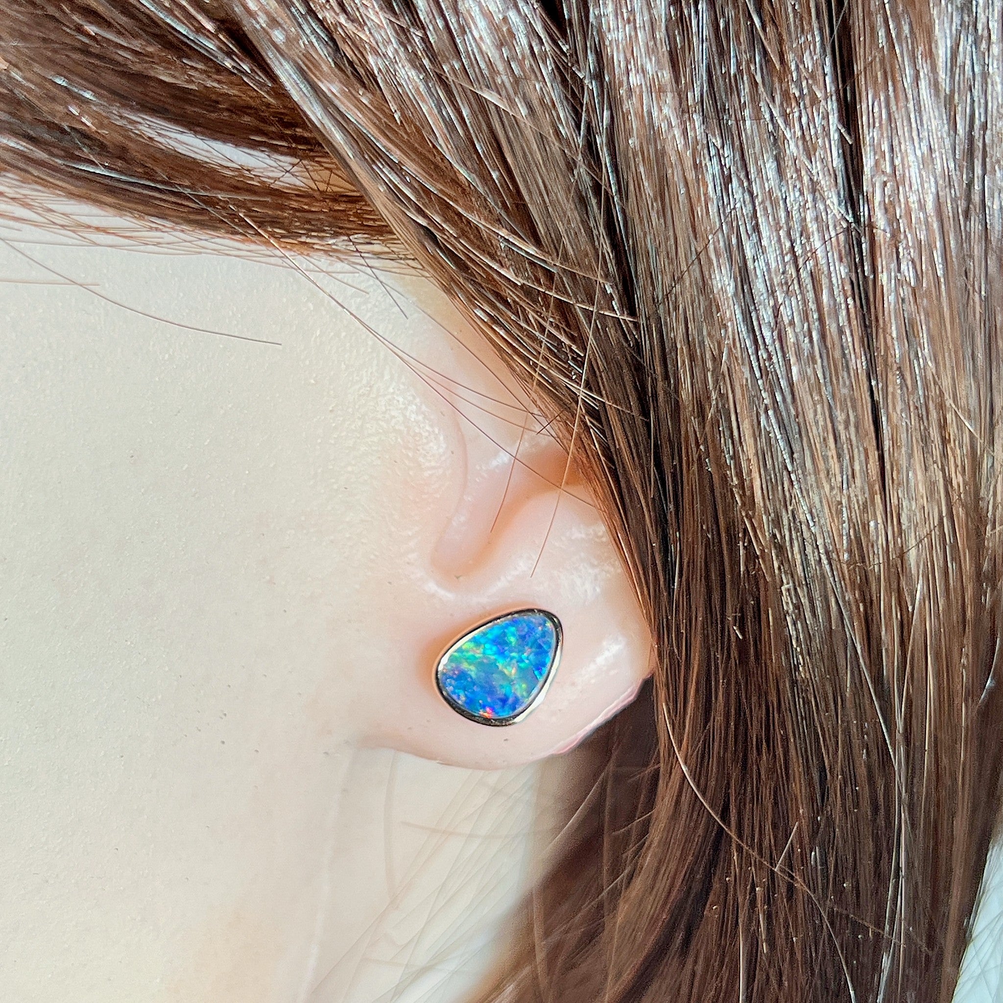 Worn Australian opal doublet earrings in rose gold-plated silver, red, blue and green, 10 x 8mm