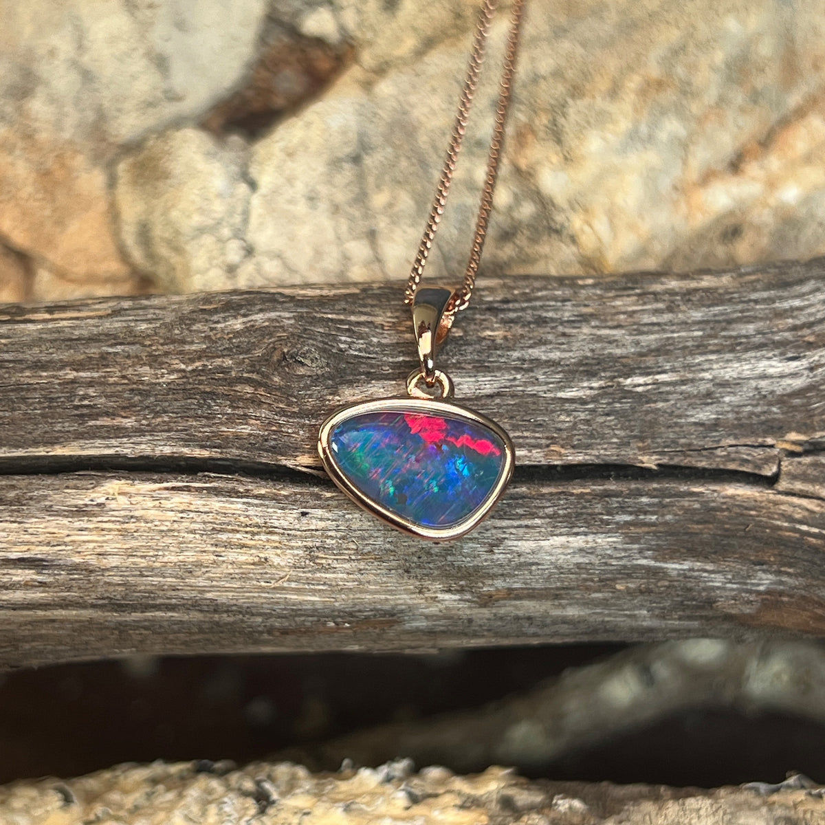 freeform Australian opal triplet pendant in yellow gold-plated silver, red, green and blue play-of-colour