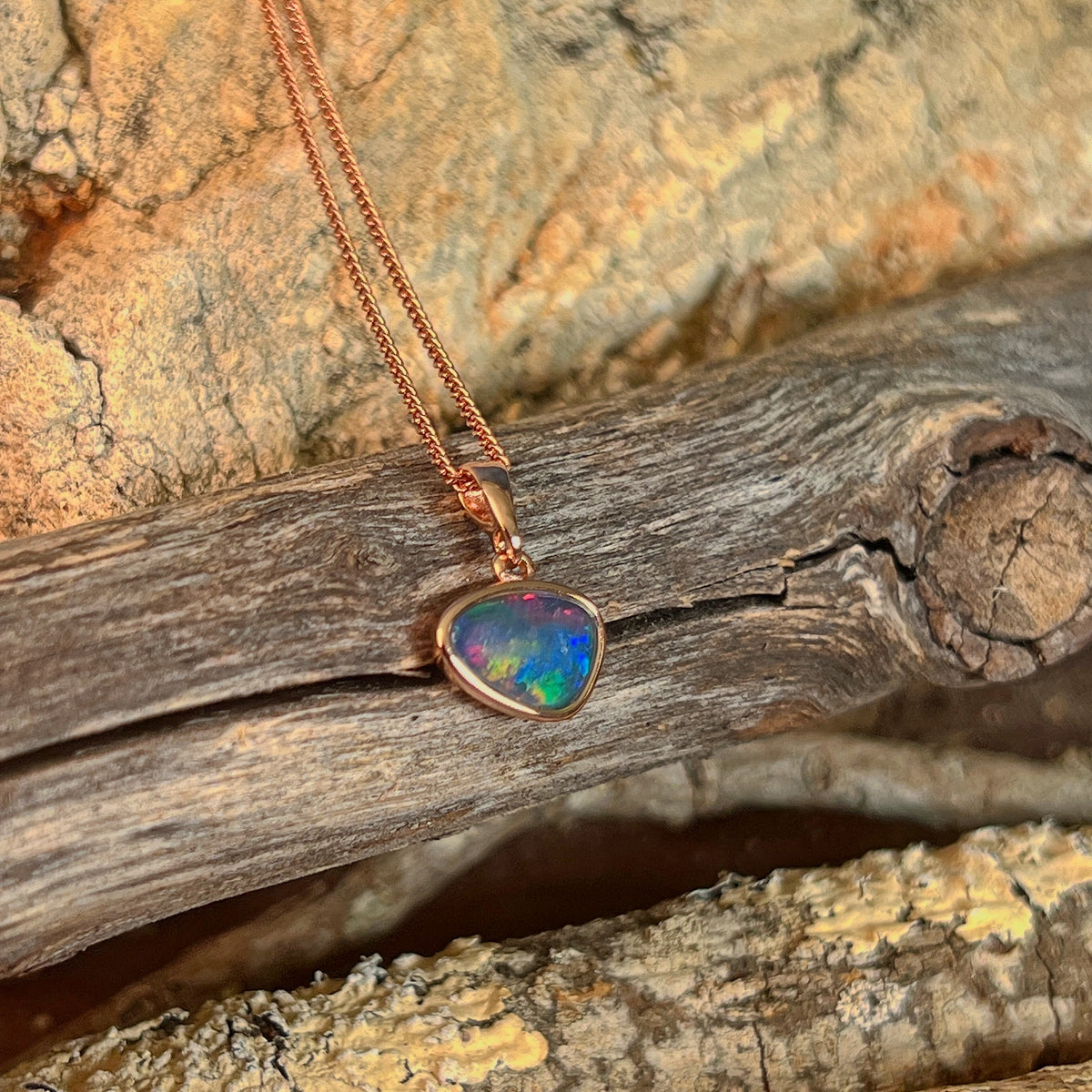 freeform Australian opal triplet pendant in yellow gold-plated silver, 12 x 8mm, red, green and blue