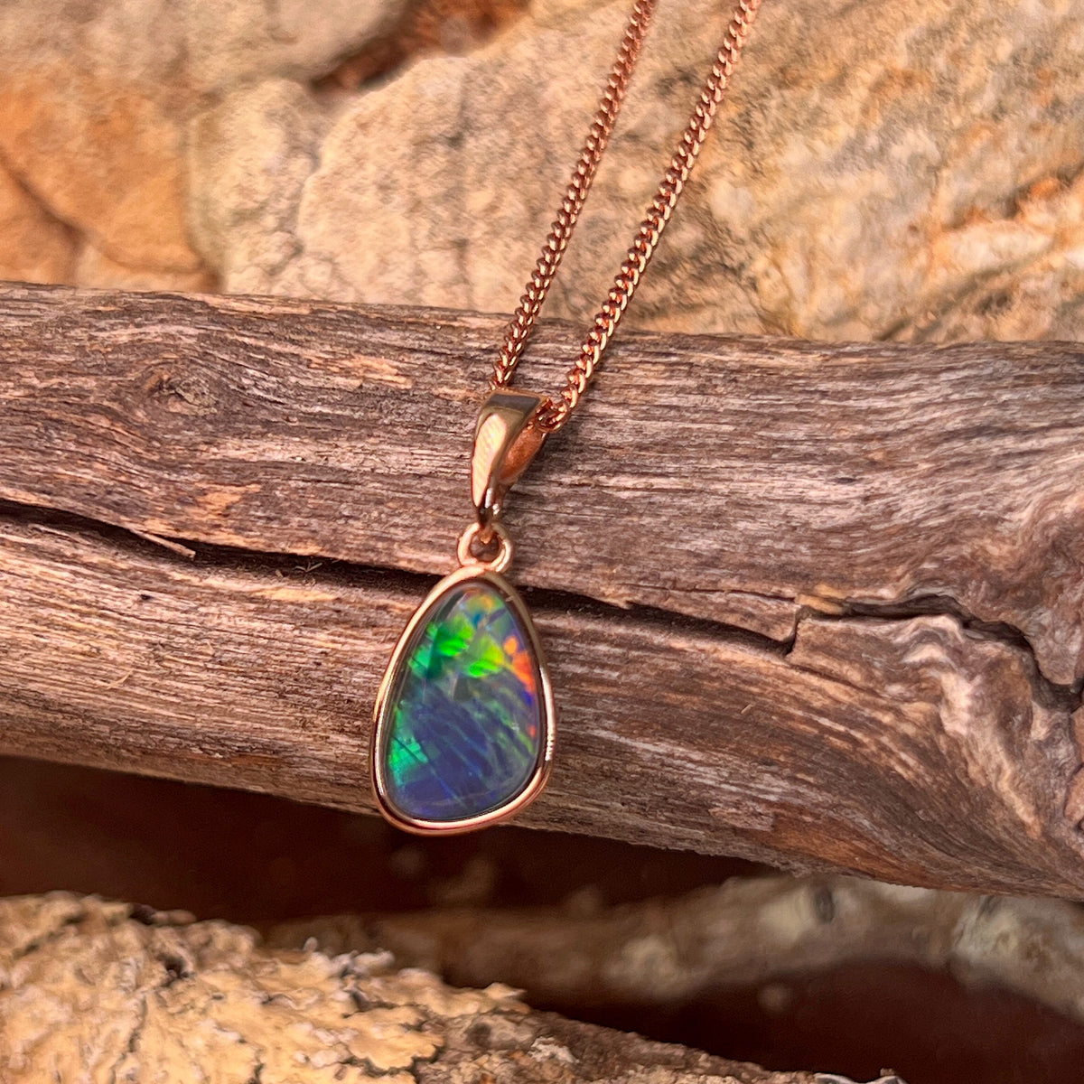 freeform Australian opal triplet pendant in rose gold-plated silver, 12 x 8mm, red, green and blue
