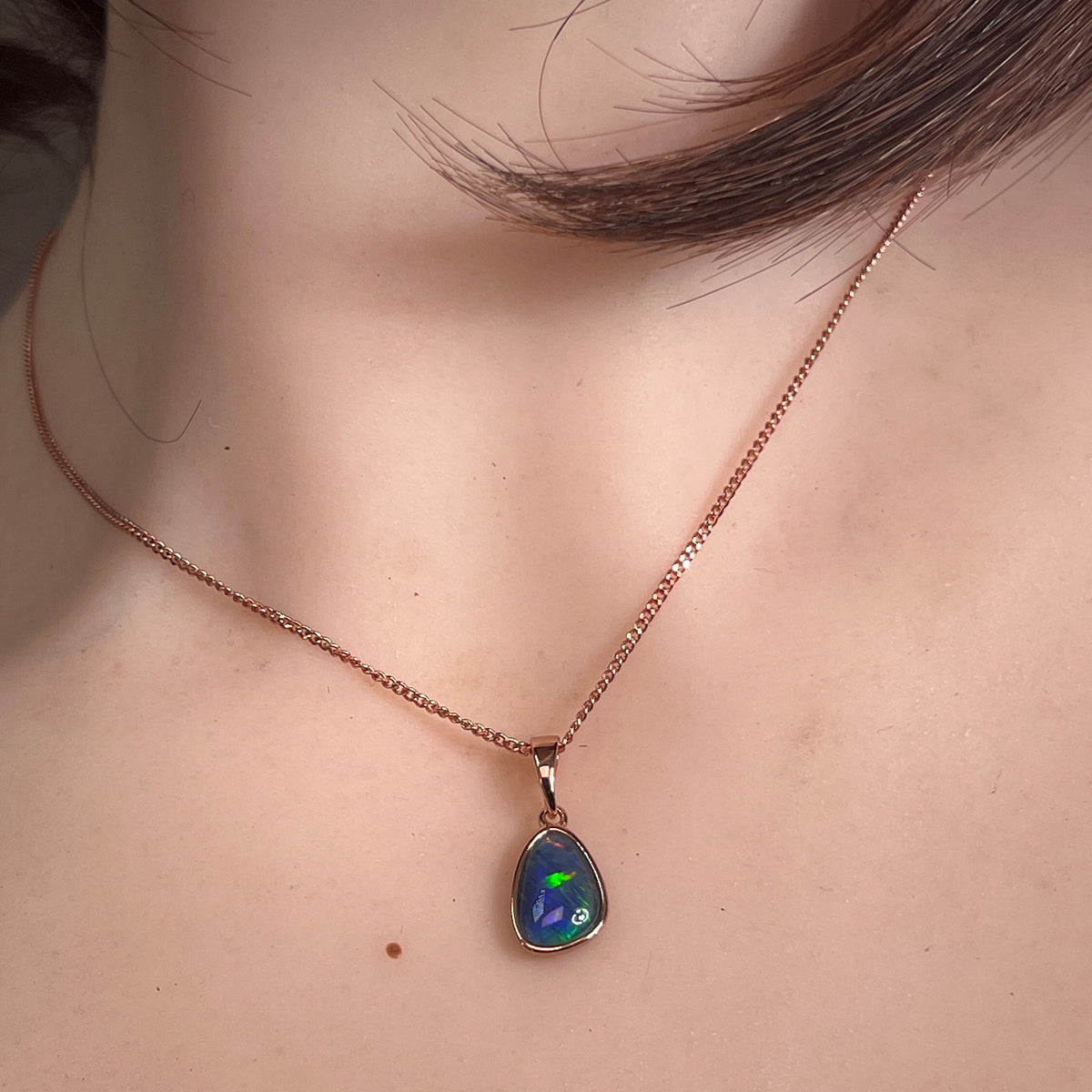 red, green and blue Australian opal triplet pendant worn at the neck, rose gold-plated silver, 12 x 8mm