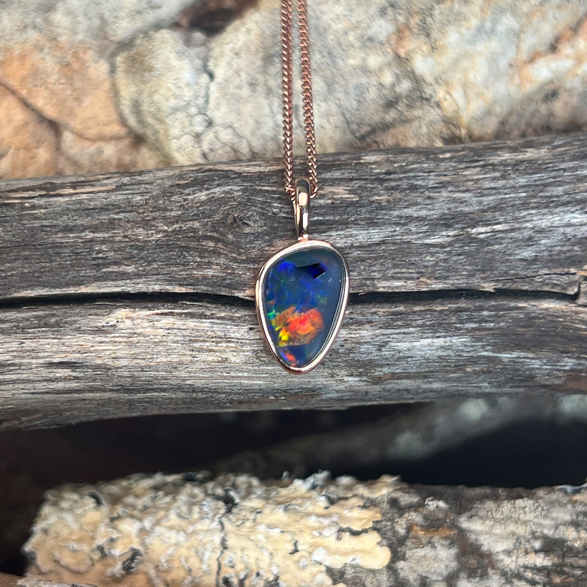 Australian opal triplet pendant, rose gold-plated silver, freeform 12 x 8mm stone, red, green and blue