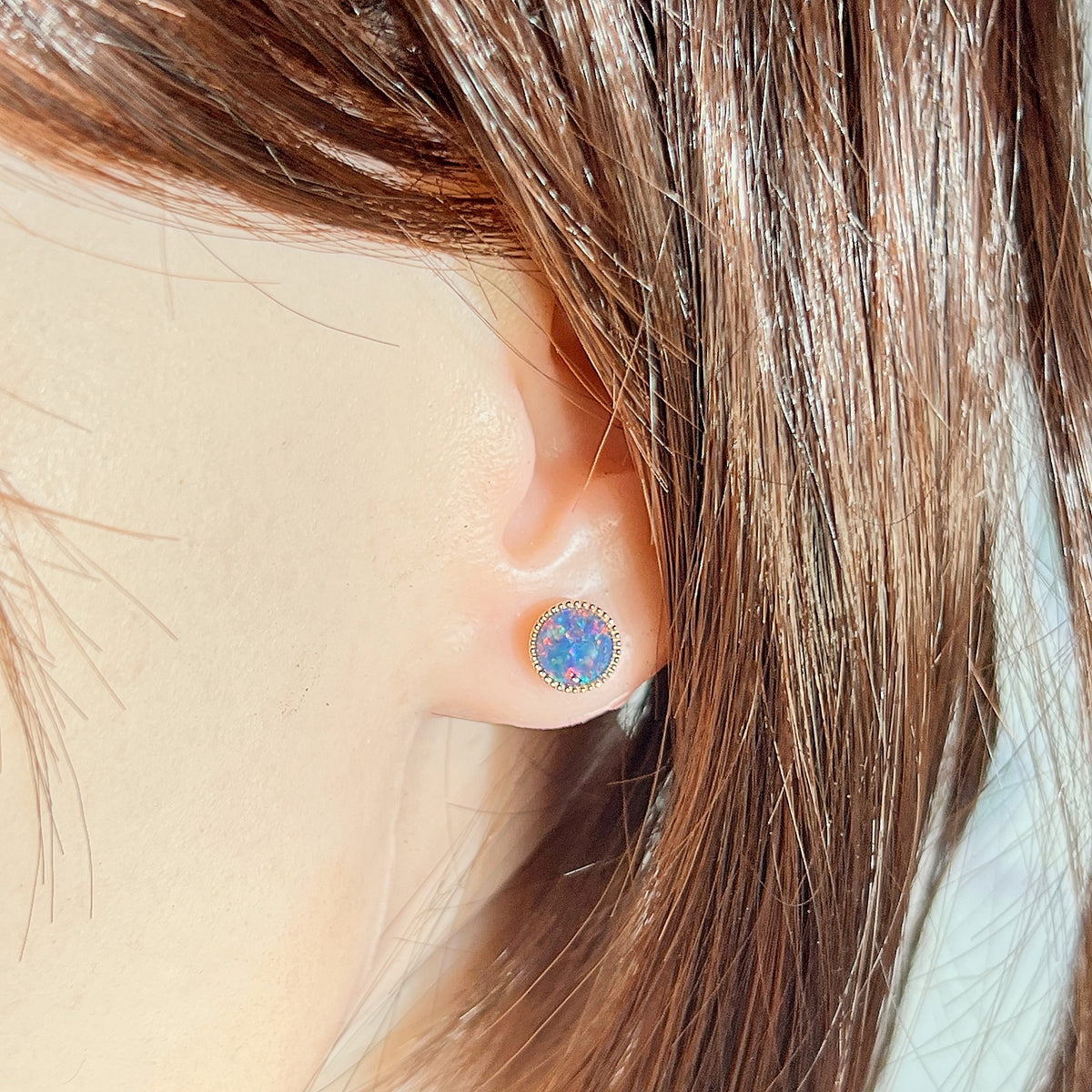 round Australian opal triplet earrings in rose gold-plated silver, worn on the ear