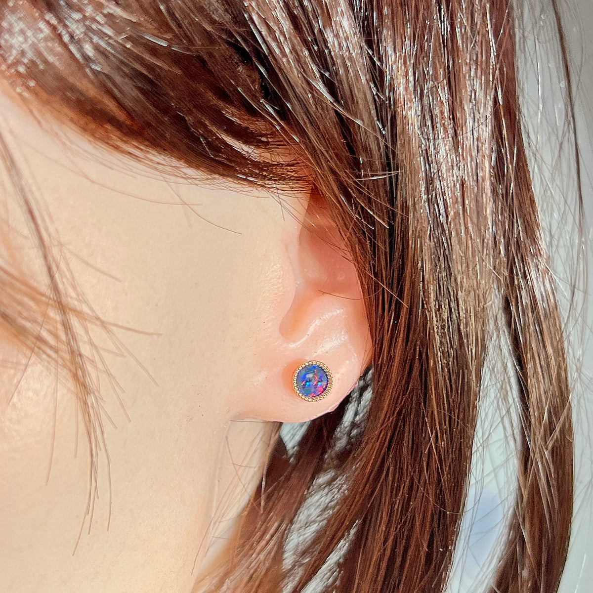 Worn Australian opal triplet earrings in rose gold-plated silver, red, blue and green, 6mm