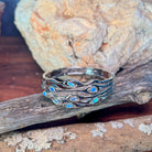 Australian opal set into the wave cut-out band of a sterling silver bangle