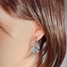 Worn view of the sterling silver Australian opal circle earrings