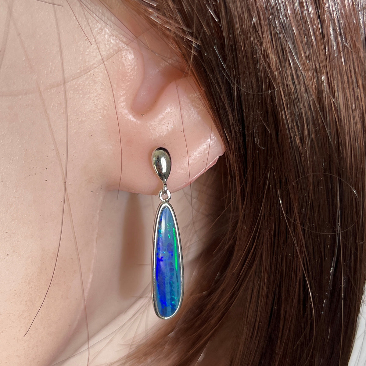 Australian opal doublet earrings worn on the ear, sterling silver, 23 x 6mm freeform stones