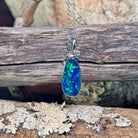Sterling silver freeform opal doublet pendant angled to show its decorative bail