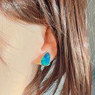 Opal doublet stud earring in sterling silver worn on the ear, side profile view