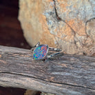 Close view of the blue, red and green play of colour in the marquise opal doublet