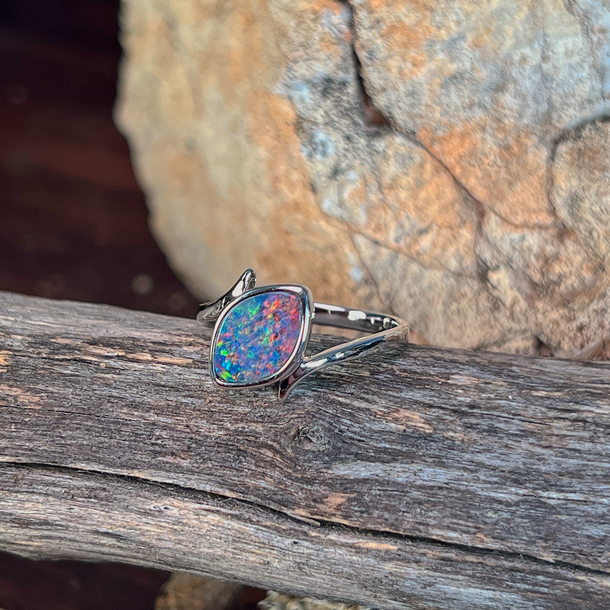 Close view of the blue, red and green play of colour in the marquise opal doublet