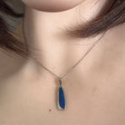 20 x 6mm oval Australian opal doublet pendant worn at the neck, sterling silver