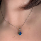 9.5 x 7mm oval Australian opal doublet pendant worn at the neck, sterling silver