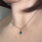 7 x 5mm oval Australian opal doublet pendant worn at the neck, sterling silver