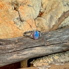 Close view of the blue, red and green play of colour in the oval opal doublet