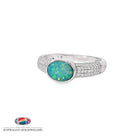 Oval opal doublet ring in sterling silver on a band pave set with cubic zirconia, showing blue, red and green play of colour