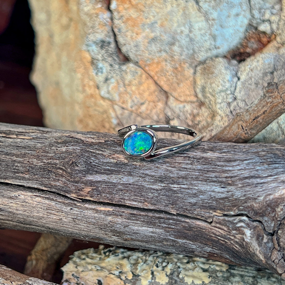 Close view of the blue, red and green play of colour in the oval opal doublet