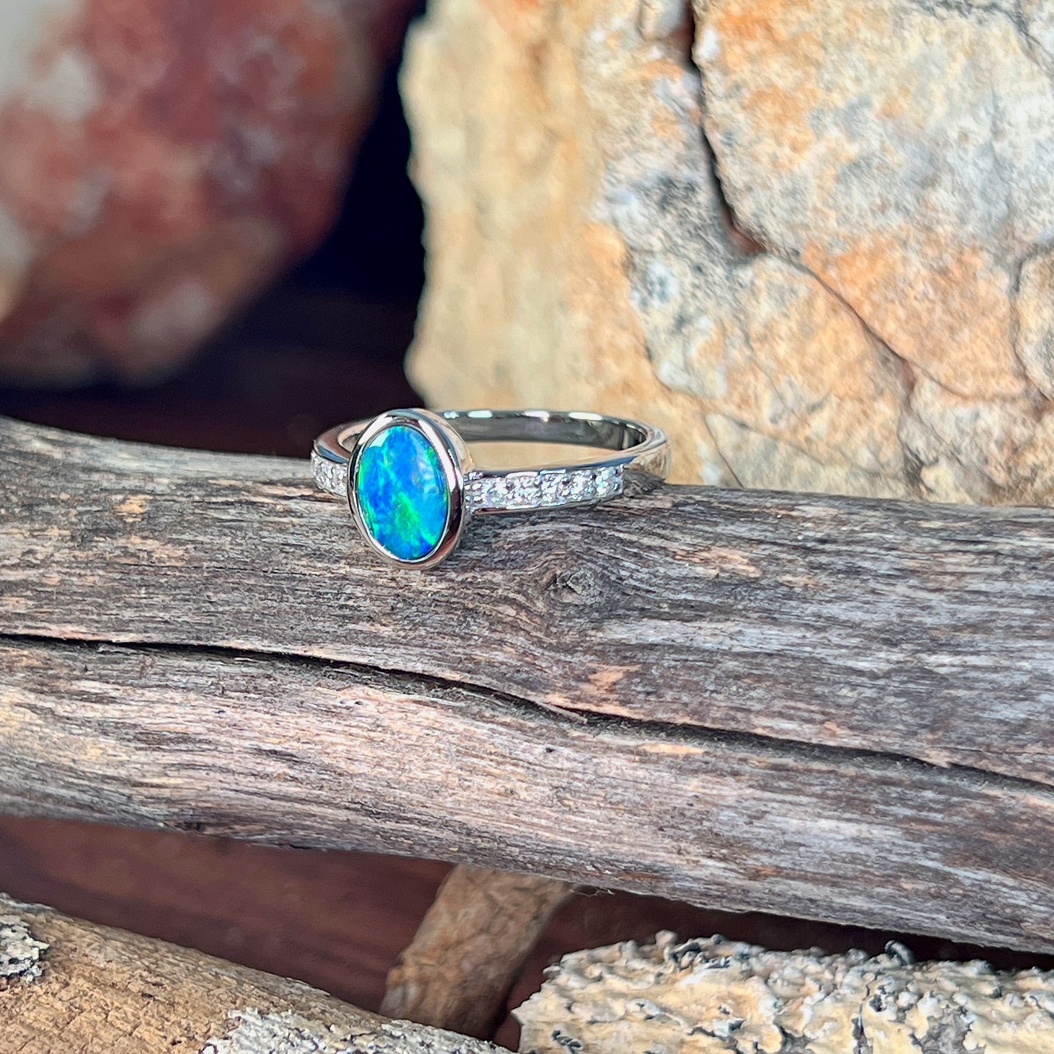Close view of the blue, red and green play of colour in the oval opal doublet