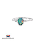 Oval opal doublet ring in sterling silver with a cubic zirconia to each side, showing blue, red and green play of colour
