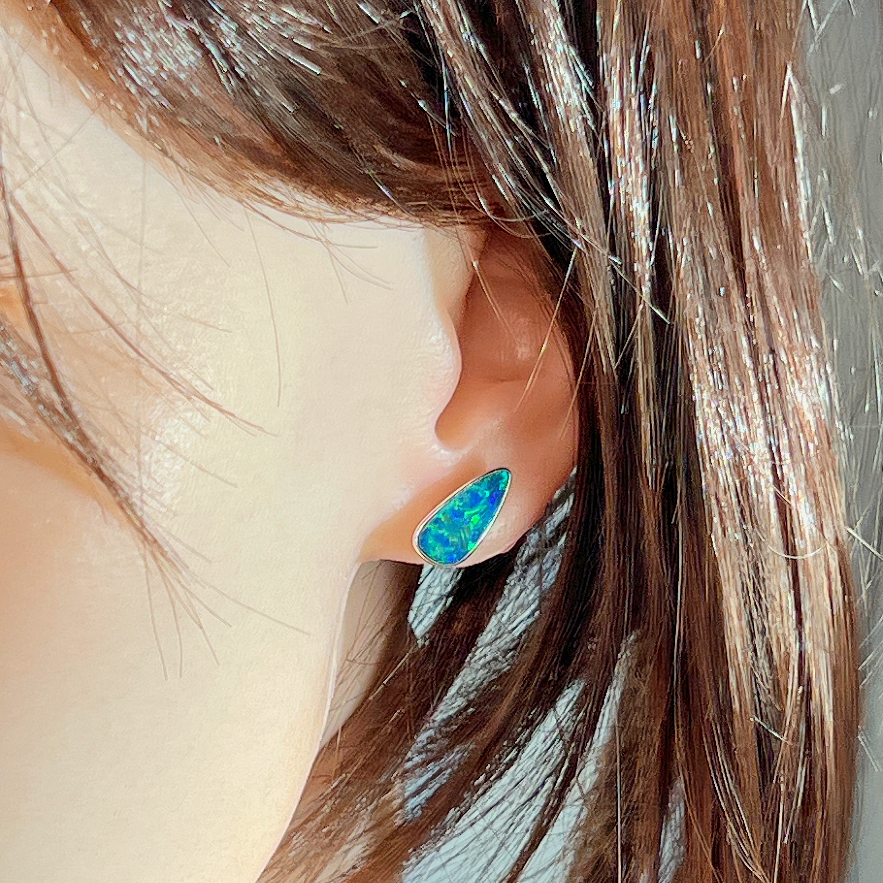 Sterling silver teardrop opal doublet stud worn on the ear, side profile view