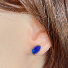 11 x 6mm pear-shaped Australian opal doublet earrings worn on the ear, sterling silver
