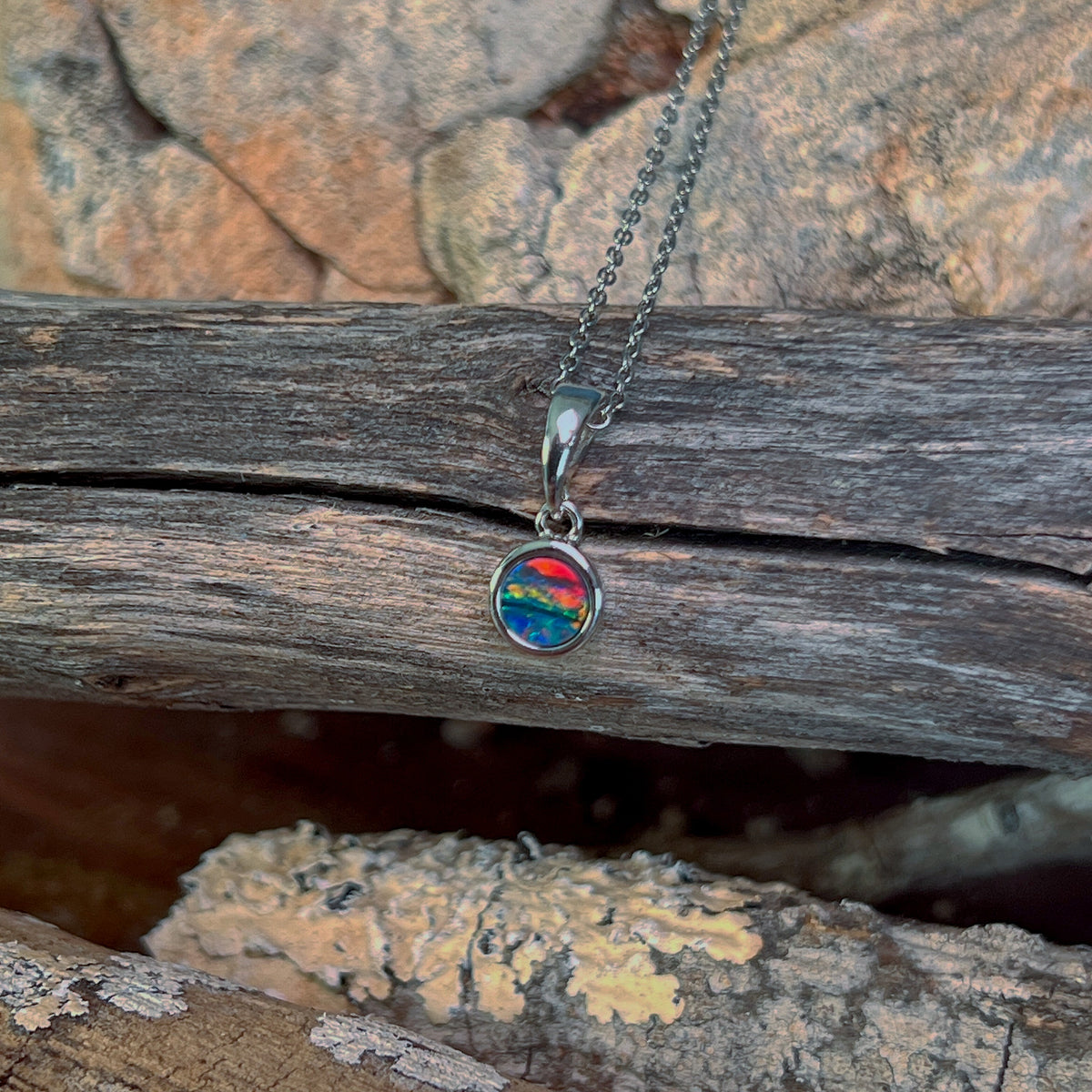 red, blue and green play-of-colour in a 5mm round Australian opal doublet pendant