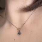 5mm round Australian opal doublet pendant worn at the neck, sterling silver