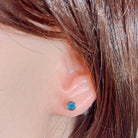 round Australian opal doublet earrings in sterling silver, worn on the ear