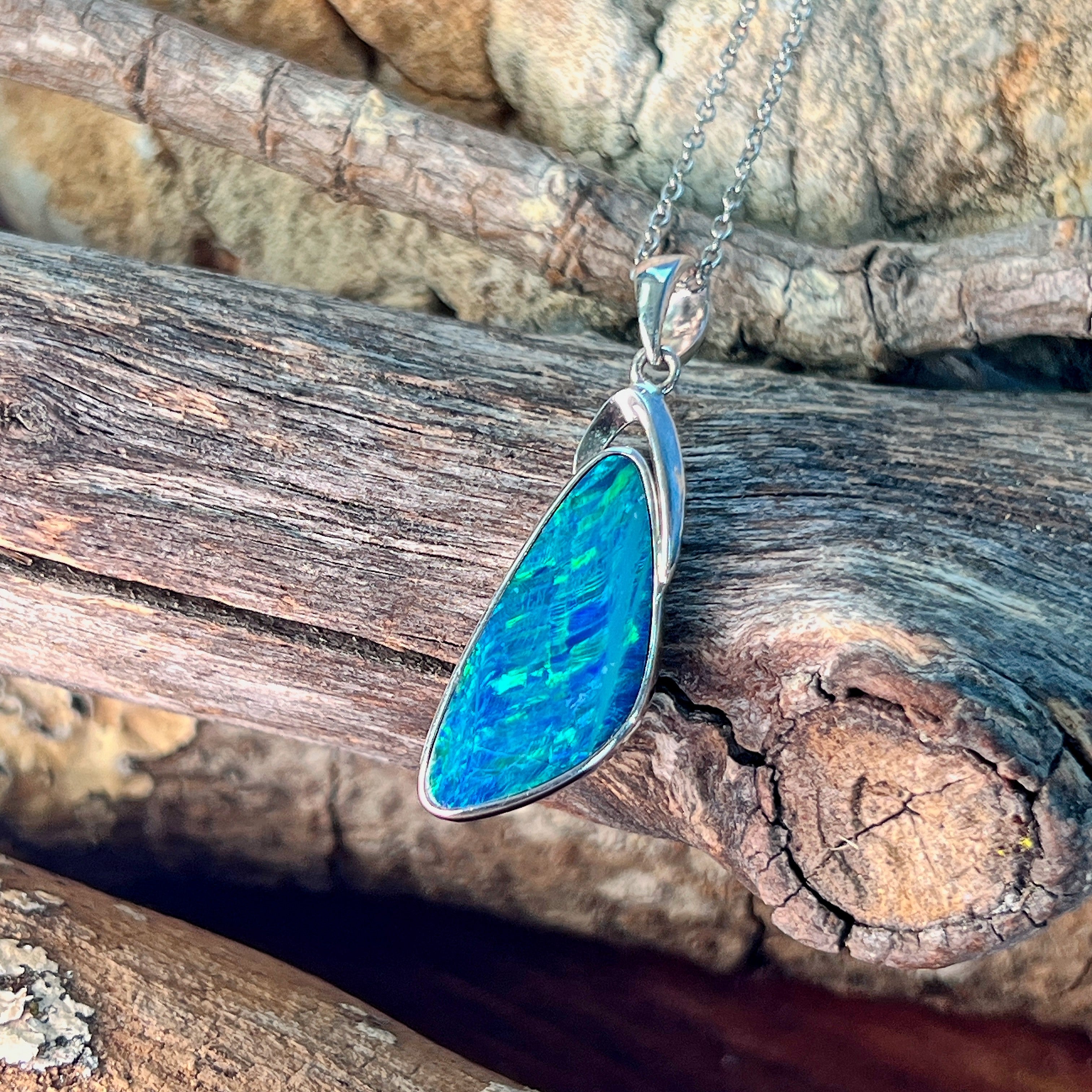 Triangular opal doublet pendant necklace in sterling silver, close view of the bezel