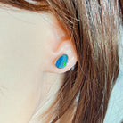 triangular Australian opal doublet earrings in sterling silver, worn on the ear