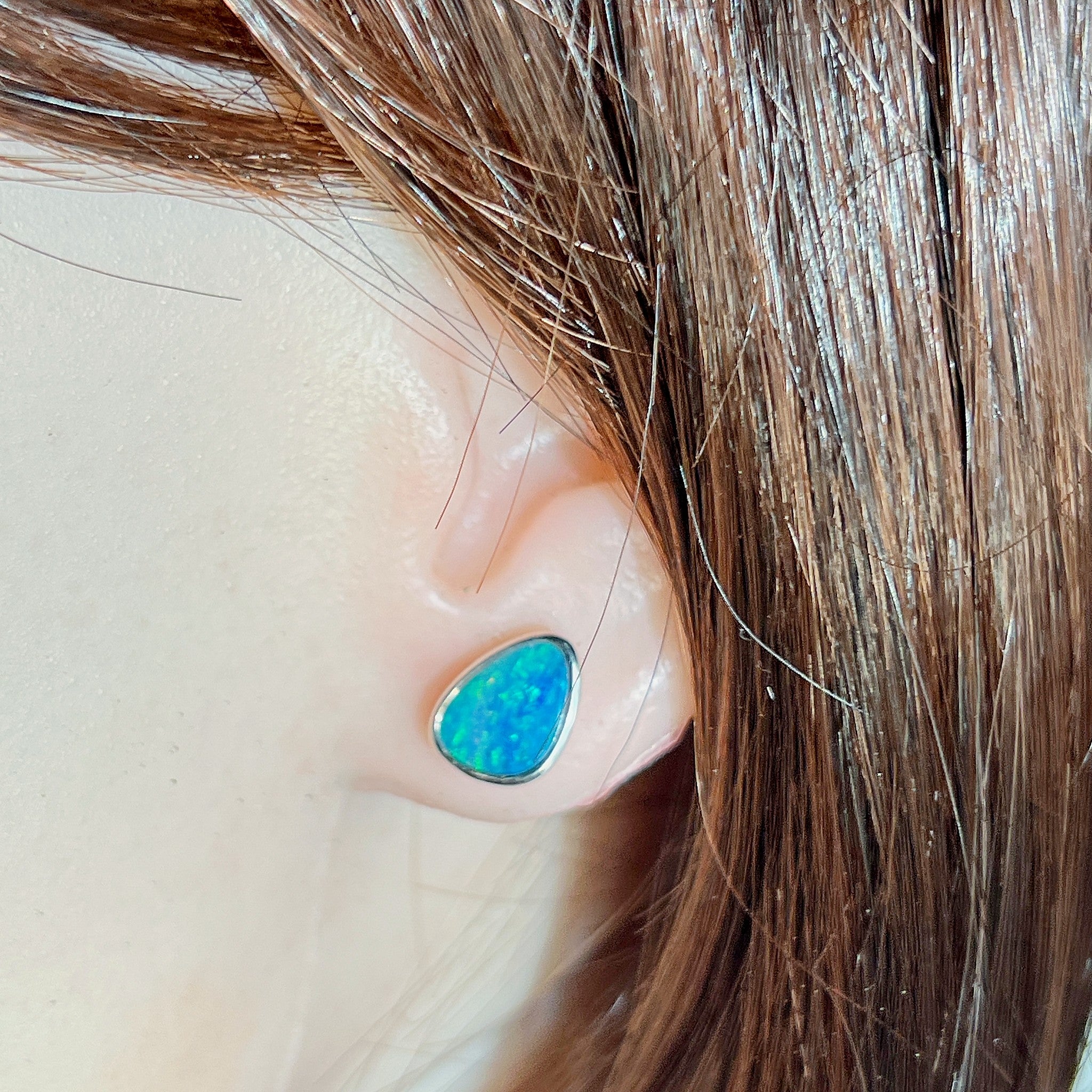Australian opal doublet earrings worn on the ear, sterling silver, 10 x 8mm triangular stones