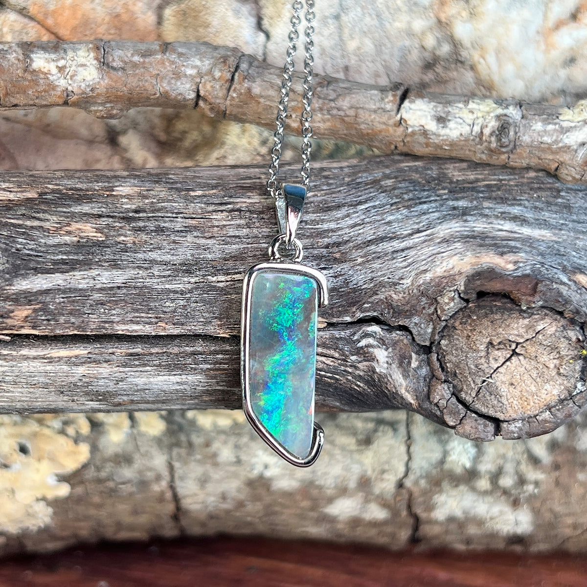 freeform Australian boulder opal pendant in sterling silver, brown, green and blue play-of-colour