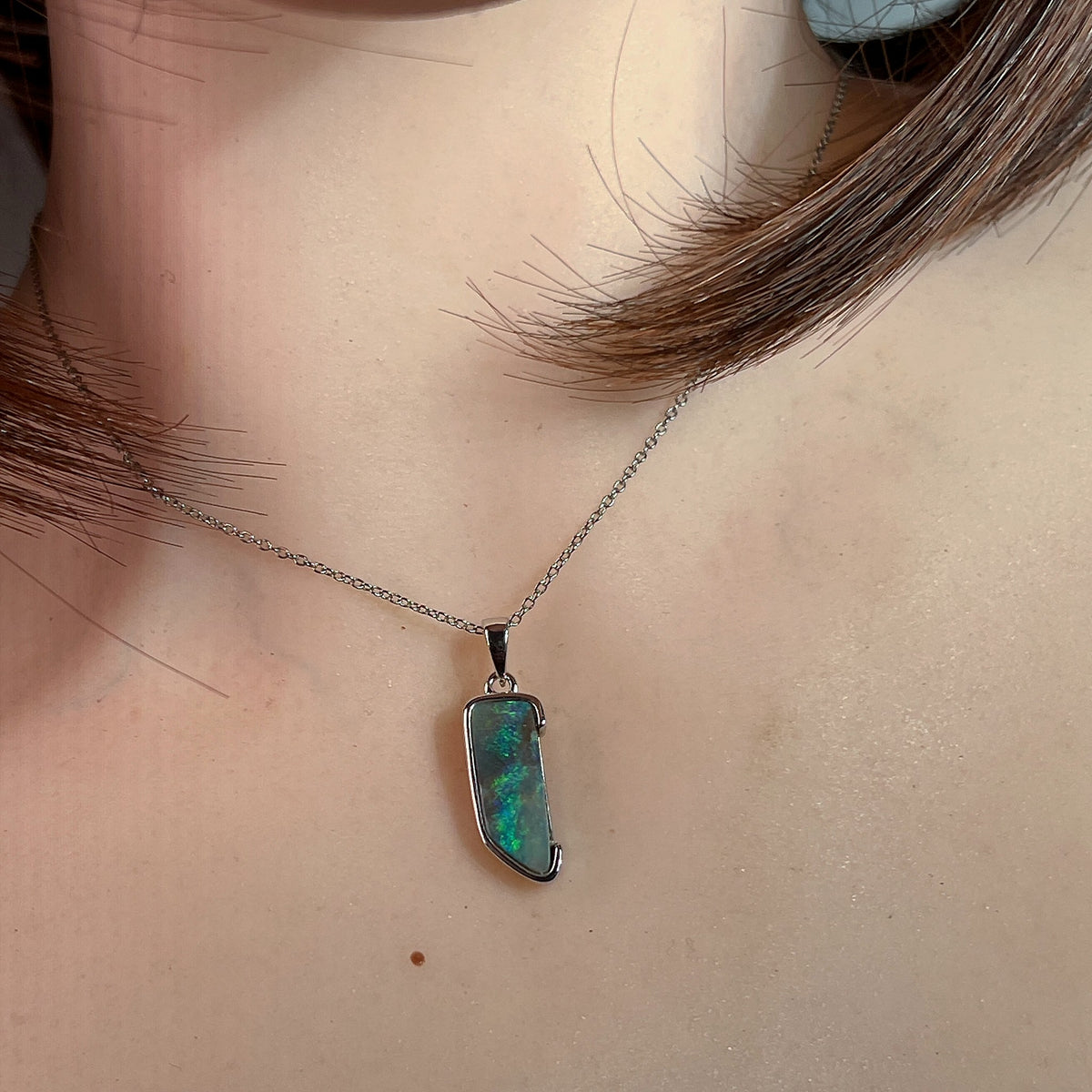 freeform Australian boulder opal pendant in sterling silver, worn at the neck