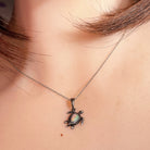 pear-shaped Australian crystal opal pendant in sterling silver, worn at the neck