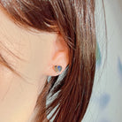 Silver heart opal triplet earring worn on the ear, side profile view