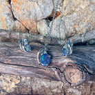 Sterling silver opal triplet jewellery set arranged along weathered driftwood