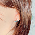 10x8mm opal triplet stud worn on the ear beneath loose hair