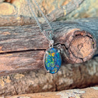 Oval opal triplet pendant in silver showing green and gold play-of-colour