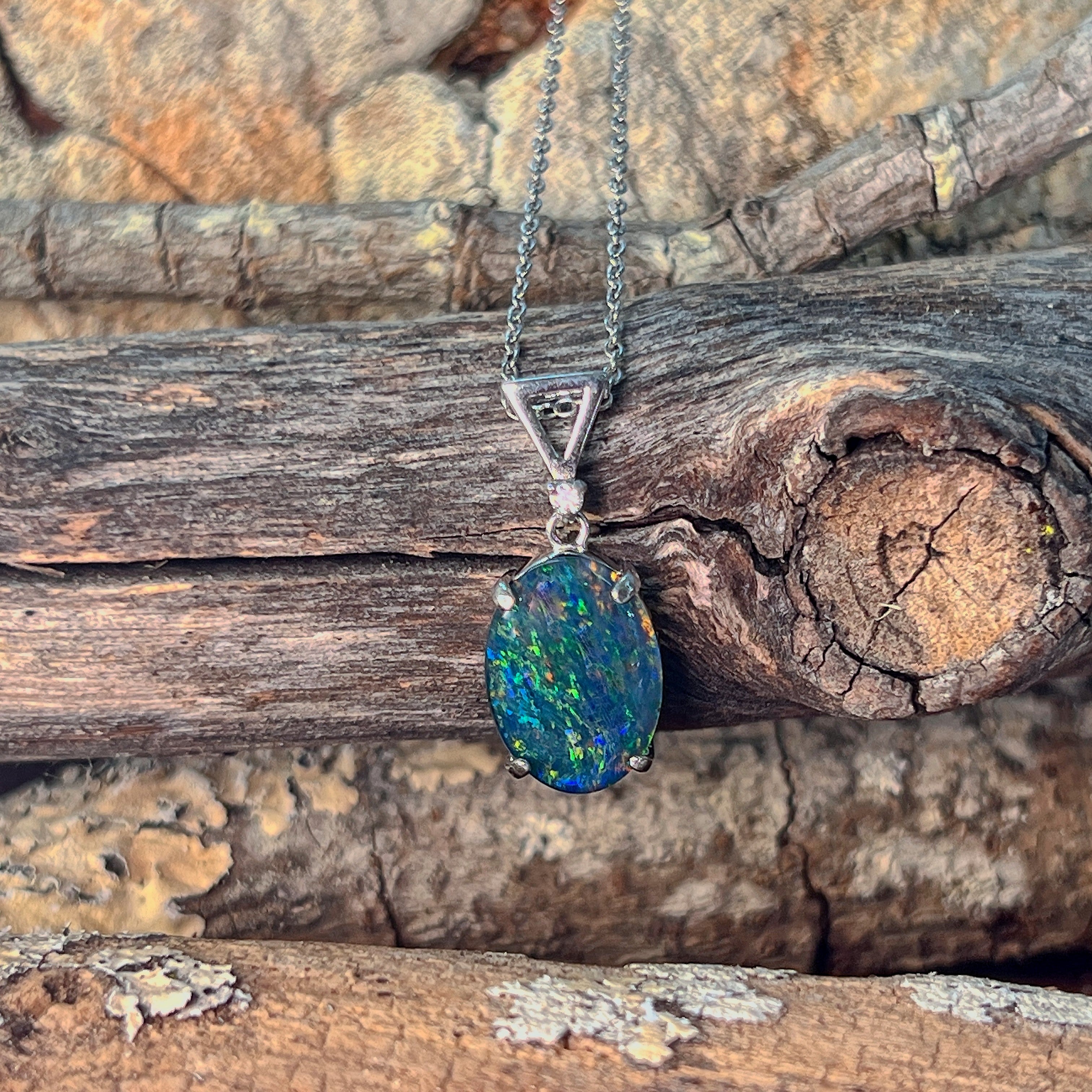 Claw-set opal triplet necklace in sterling silver, close view of the setting