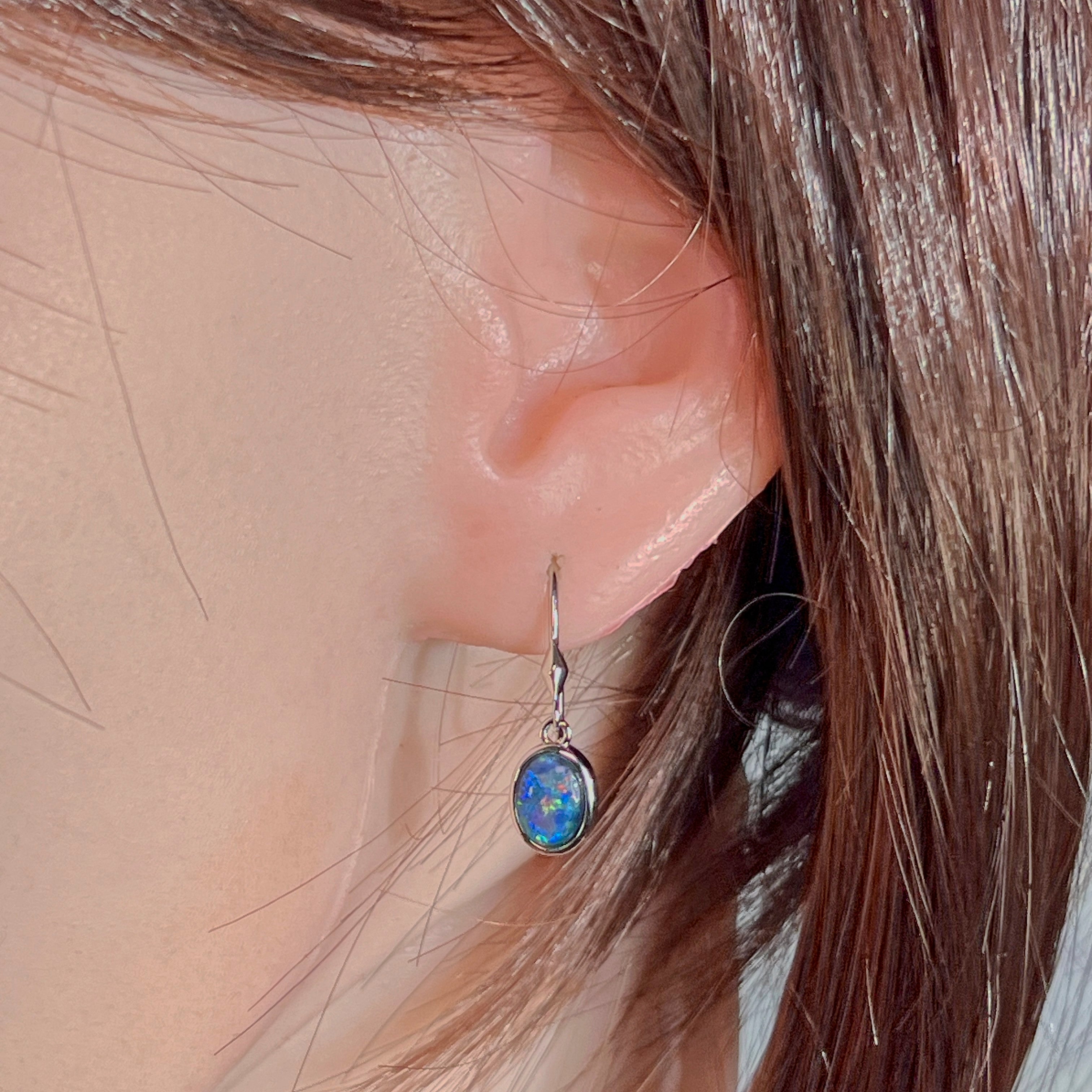 Sterling silver opal triplet dangling earring worn on the ear
