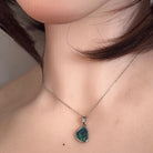 12 x 9mm freeform Australian opal triplet pendant worn at the neck, sterling silver