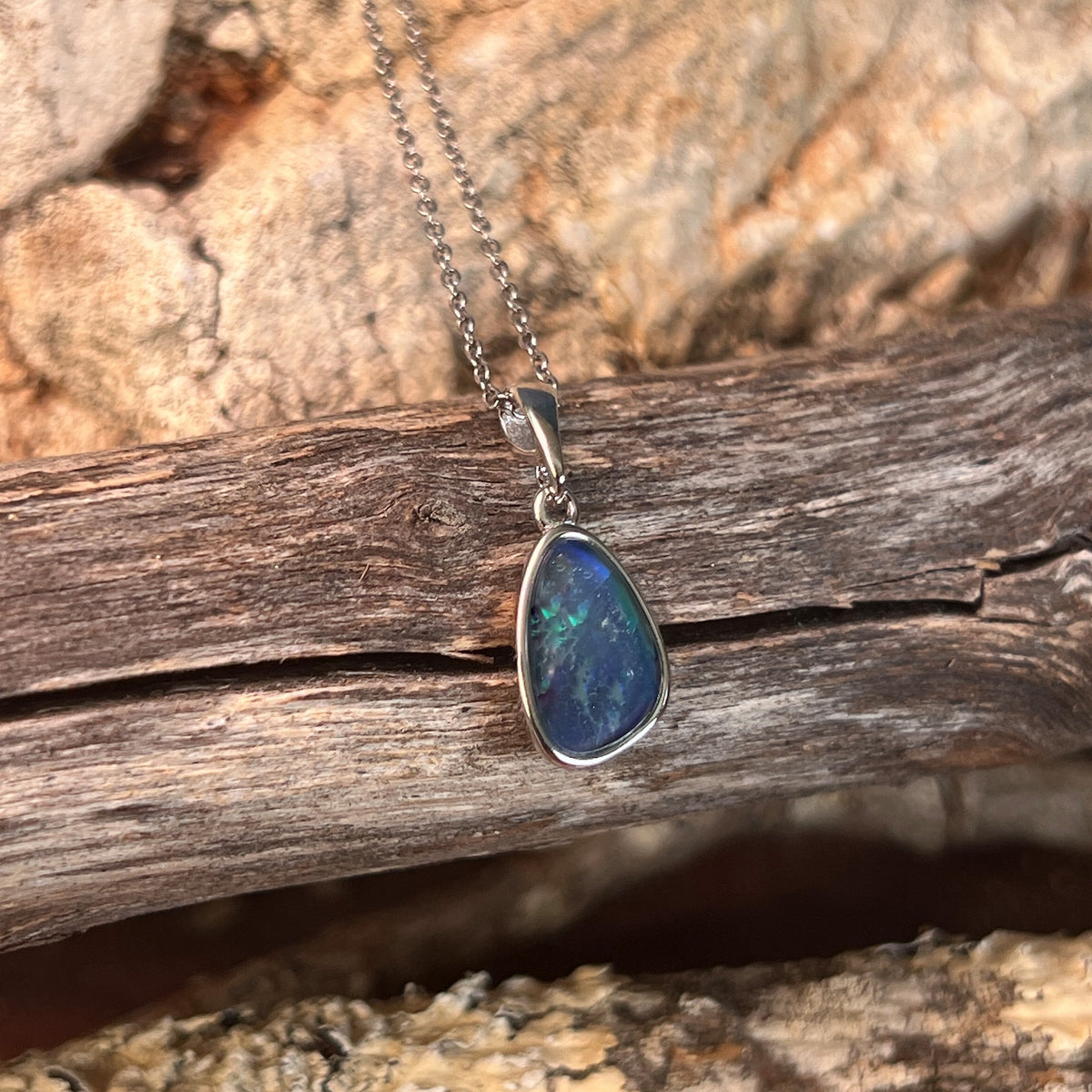 blue and green play-of-colour in a 12 x 8mm freeform Australian opal triplet pendant