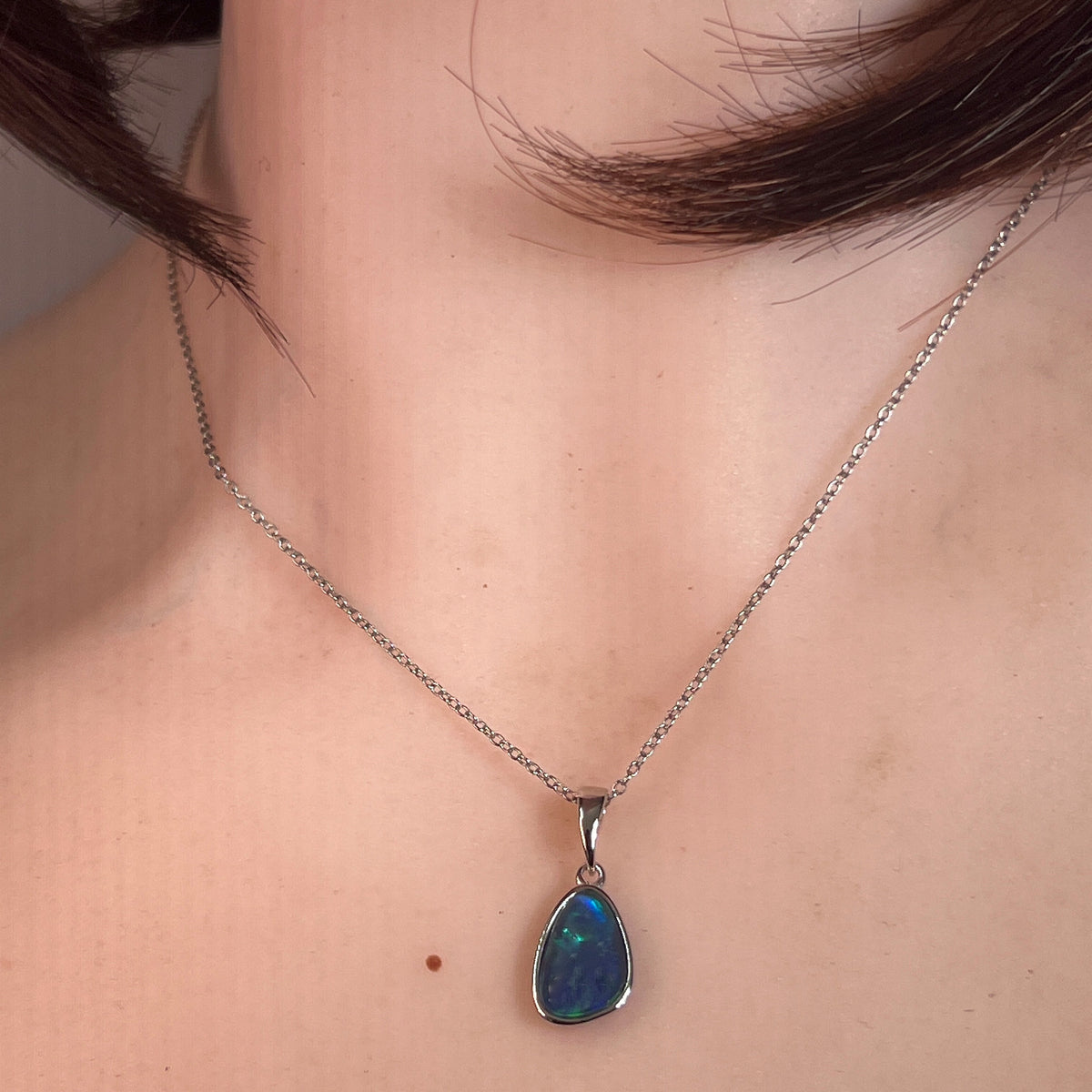 12 x 8mm freeform Australian opal triplet pendant worn at the neck, sterling silver